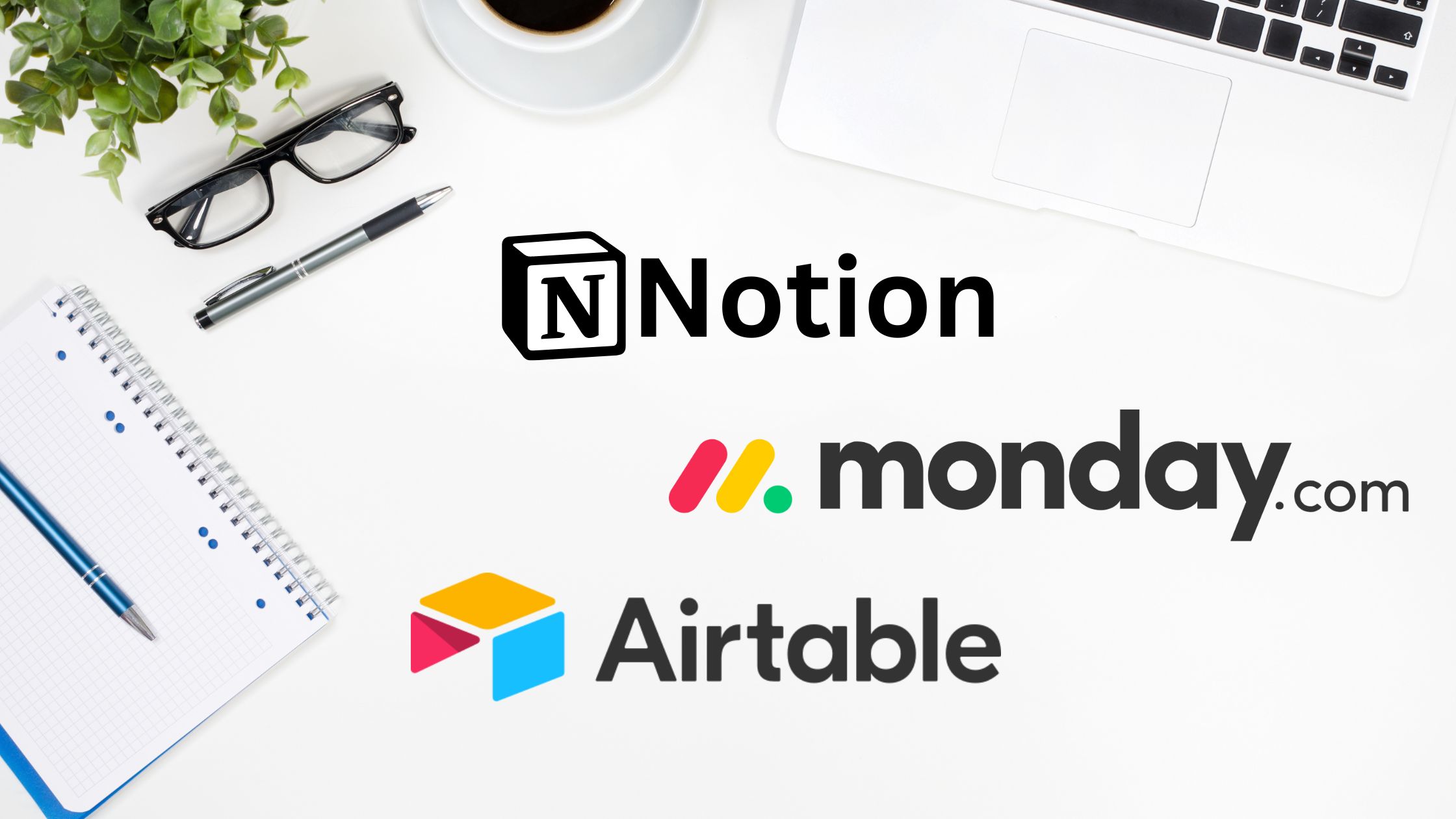 Top-down view of a white desk with a laptop, coffee cup, plant, glasses, pen, and notebook, featuring the Notion, monday.com and Airtable logos in the center.