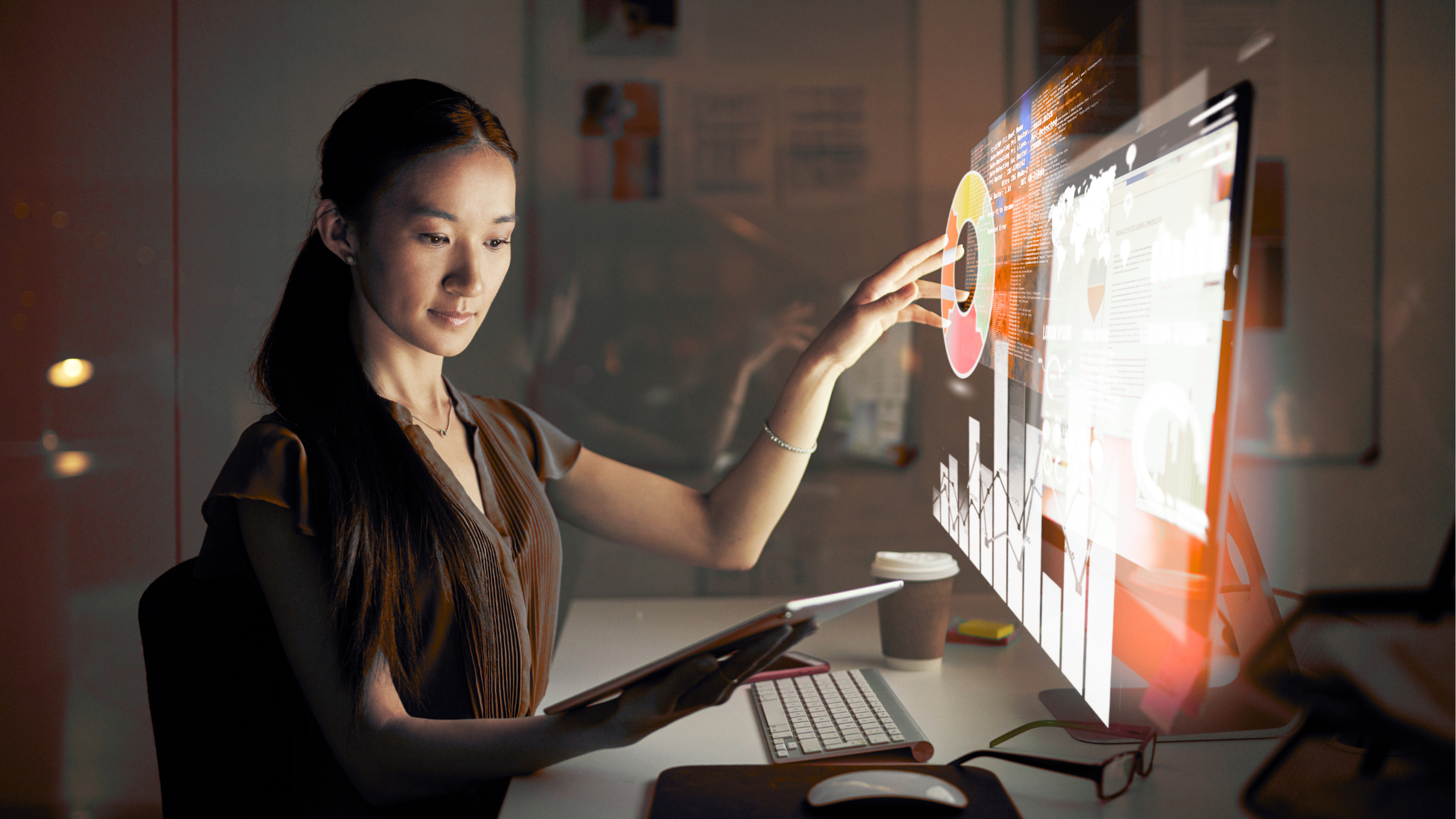 Businesswoman using futuristic data analytics dashboard on a large transparent screen, illustrating automation and productivity through business intelligence tools.